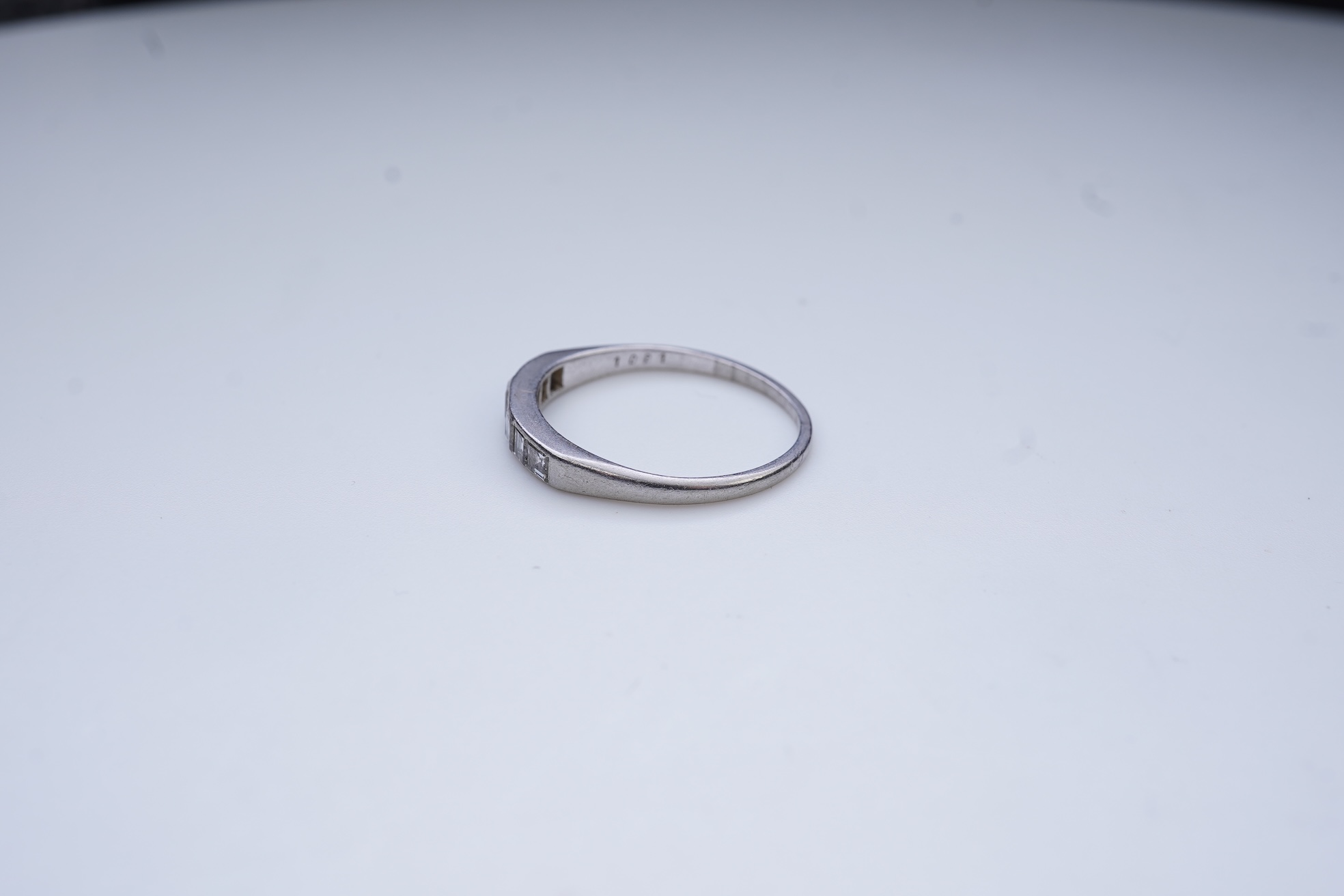 A diamond half-eternity ring, first half 20th century